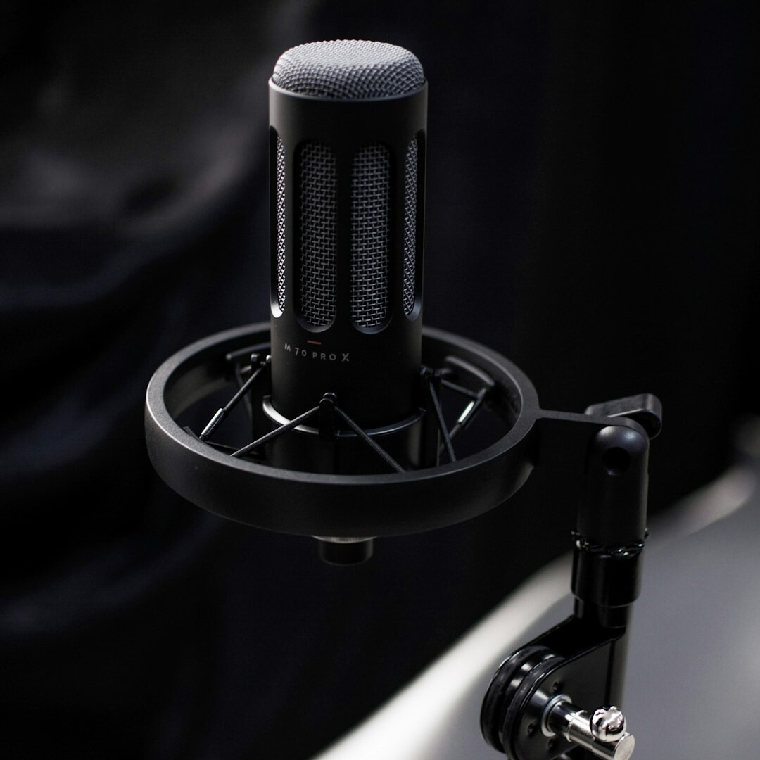 Belgian man recording a podcast in a professional studio with microphone